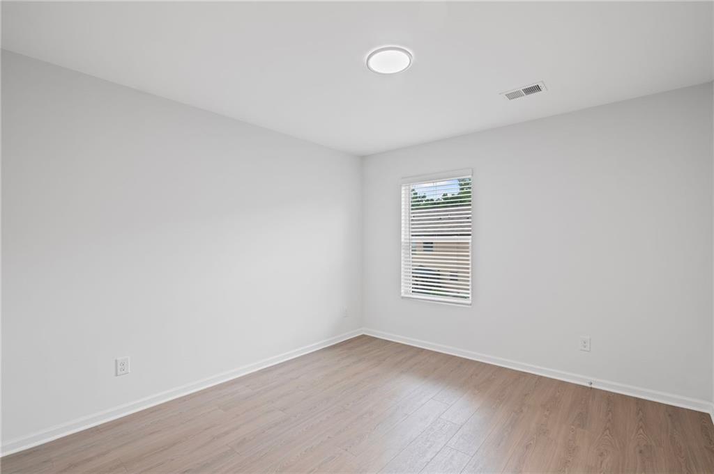 3650 River Rock Road Lithonia, GA 30038 - Photo 29 of 42 a view of an empty room with wooden floor and a window