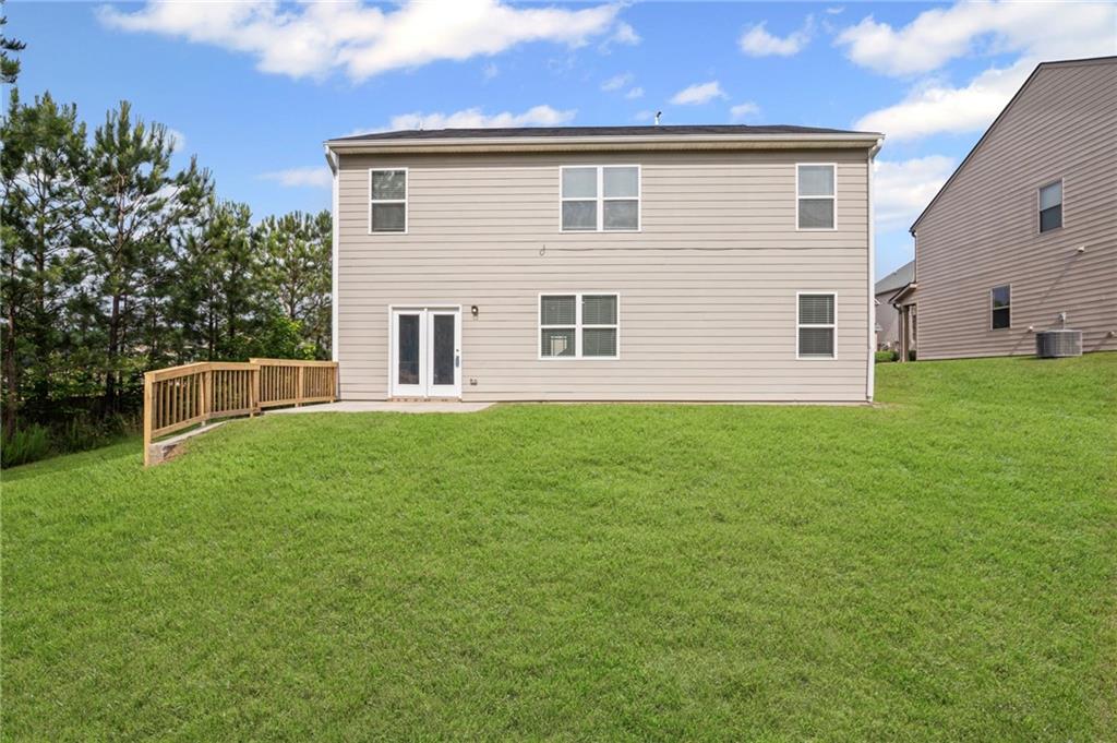 3650 River Rock Road Lithonia, GA 30038 - Photo 40 of 42 a front view of a house with a yard