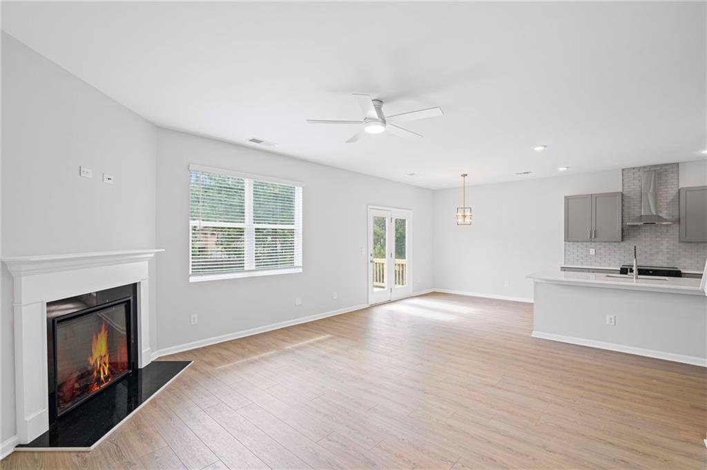 3650 River Rock Road Lithonia, GA 30038 - Photo 9 of 42 a view of an empty room with a window and fireplace