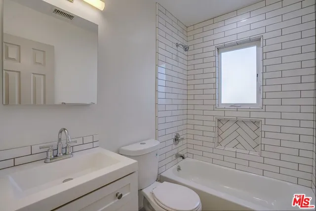 a bathroom with a sink toilet and bathtub