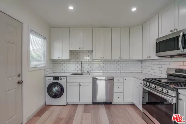 a view of a kitchen with a stove top oven