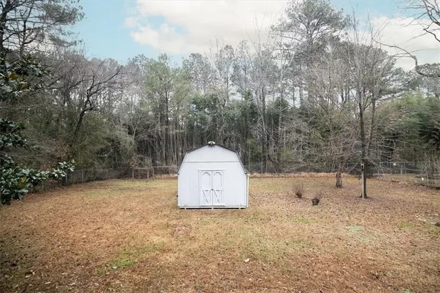 a backyard of a house with a trees and covered with fog