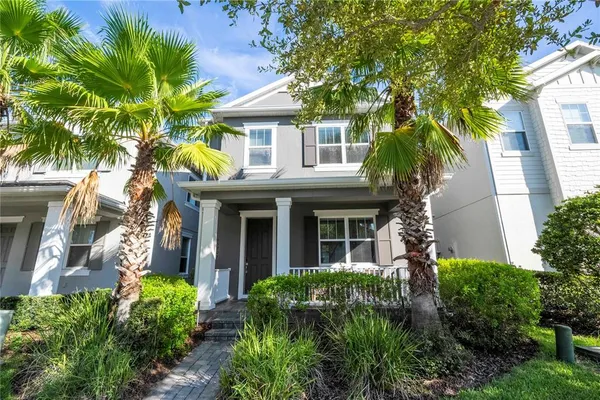 a front view of a house with plants and garden