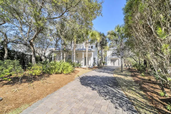 a view of a house with a yard and pathway
