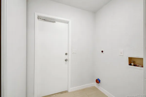 a room with a white wall and a window