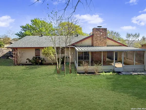a backyard of a house with table and chairs
