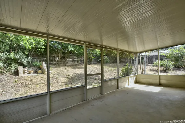 a view of a living room hardwood floor and a large window
