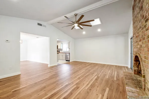 wooden floor in an empty room with a fireplace