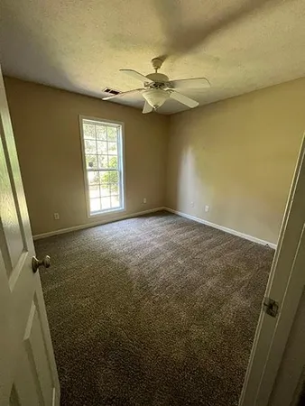a view of an empty room and a window