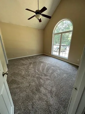 a view of an empty room and a fireplace