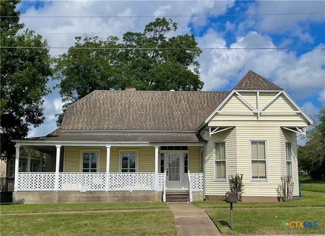 a front view of a house with a yard table and chairs