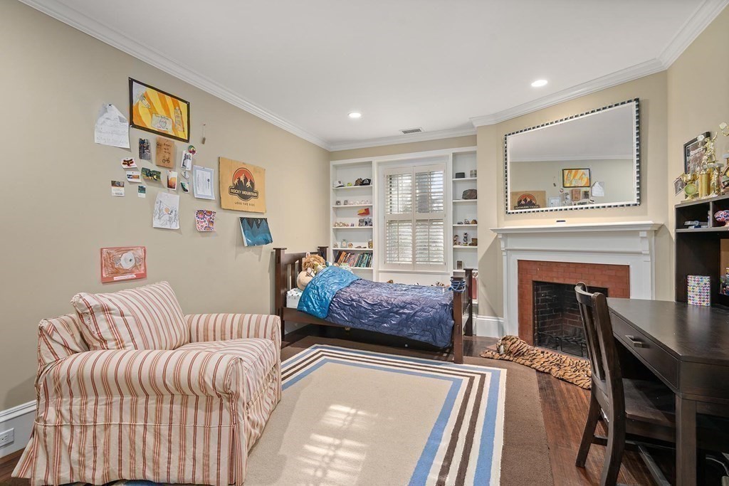 37 Circuit Road Brookline, MA 02467 - Photo 29 of 37 a bedroom with furniture and a fireplace