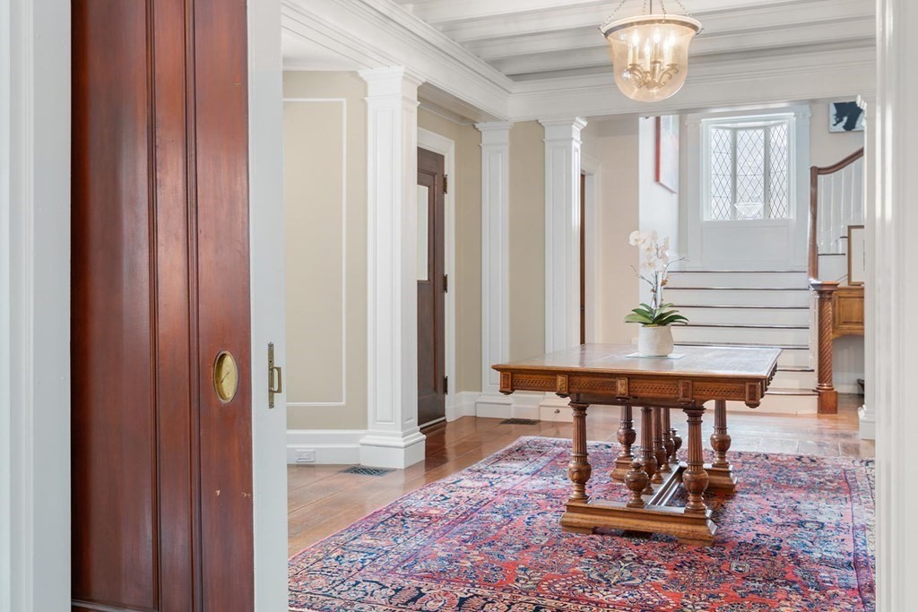 37 Circuit Road Brookline, MA 02467 - Photo 5 of 37 a view of a hallway with wooden floor and a chandelier