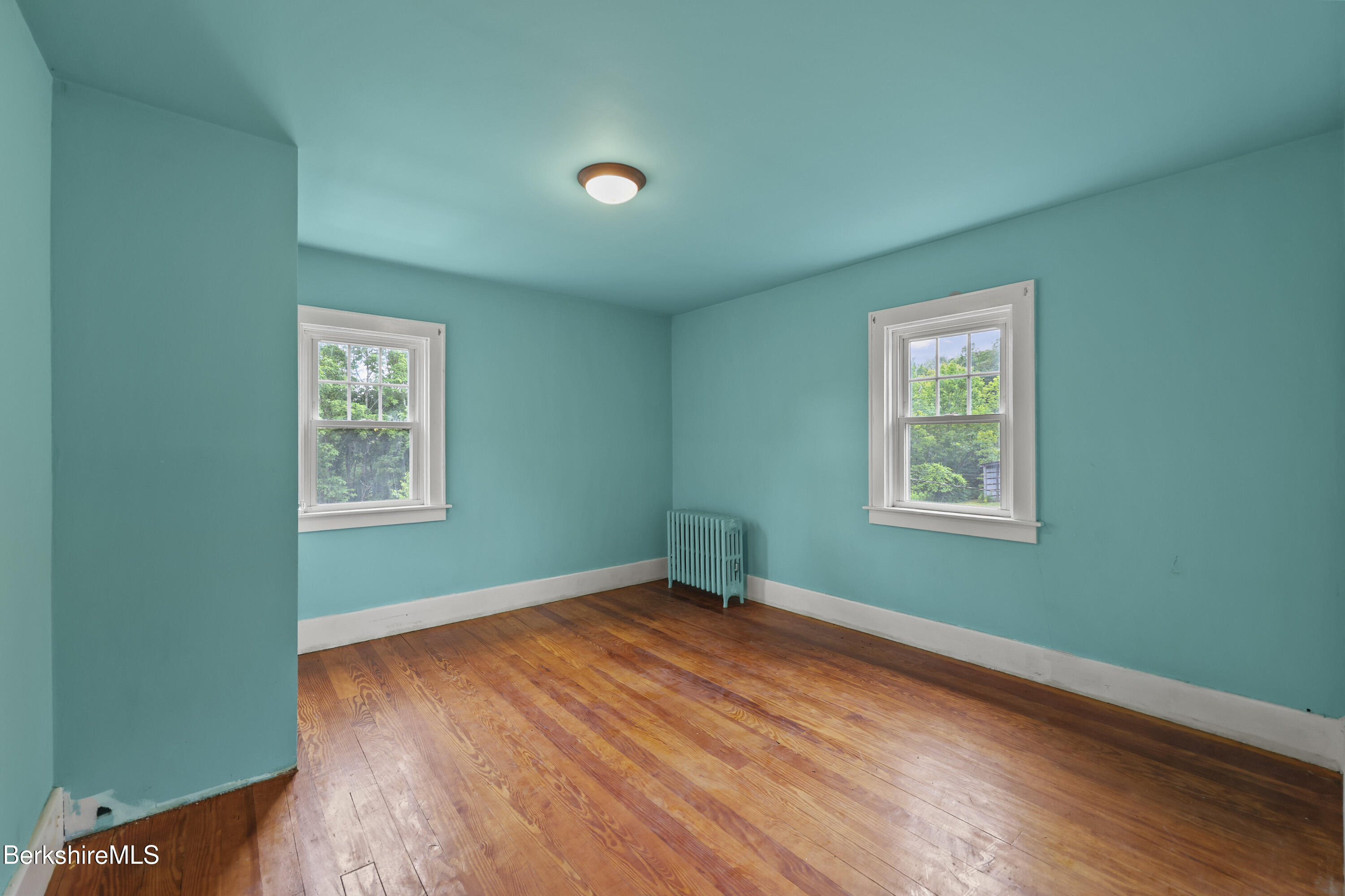 132 South Washington State Road Washington, MA 01223 - Photo 28 of 41 an empty room with wooden floor and windows