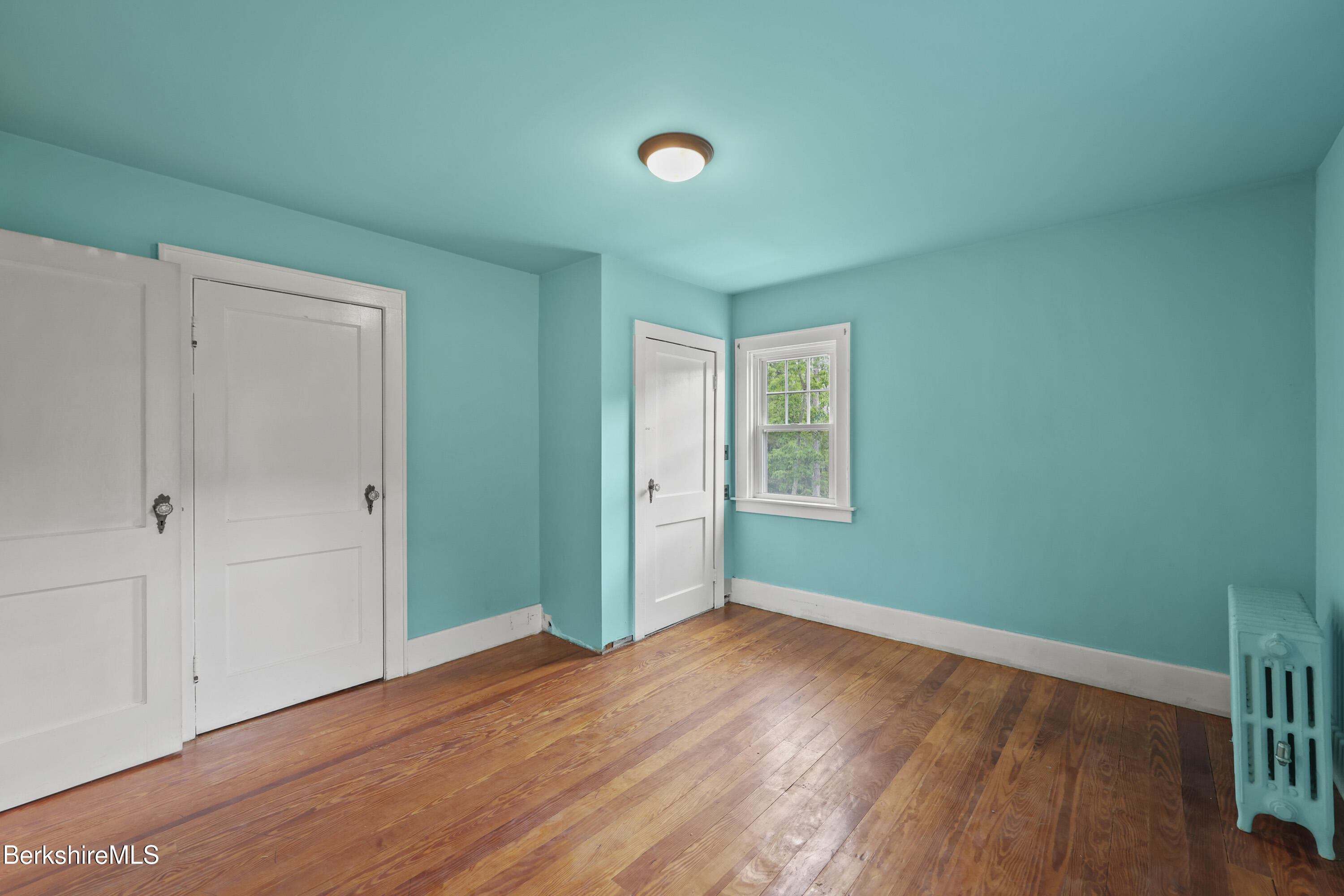 132 South Washington State Road Washington, MA 01223 - Photo 29 of 41 an empty room with wooden floor and windows