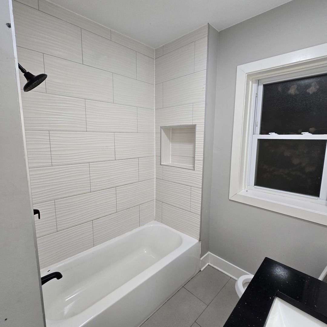7529 North Claremont Avenue, Unit 2 Chicago, IL 60645 - Photo 11 of 24 a bathroom with a bathtub and a shower