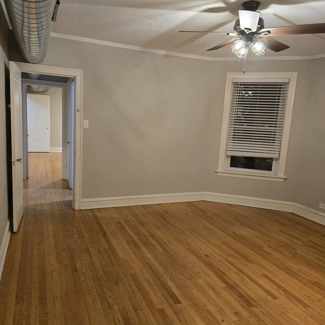 7529 North Claremont Avenue, Unit 2 Chicago, IL 60645 - Photo 15 of 24 a view of an empty room with wooden floor and a window