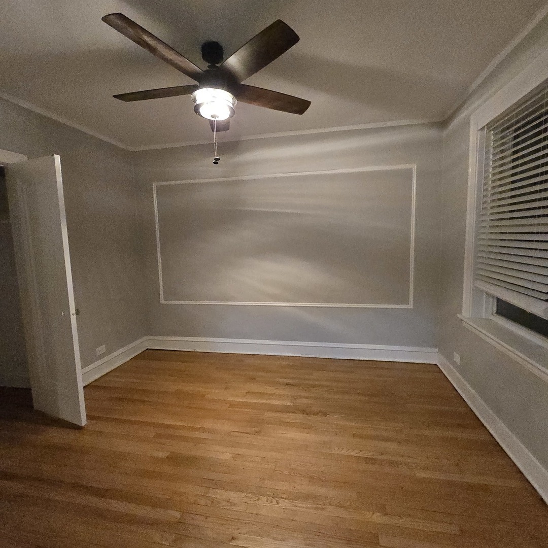 7529 North Claremont Avenue, Unit 2 Chicago, IL 60645 - Photo 20 of 24 a view of an empty room with wooden floor and a window