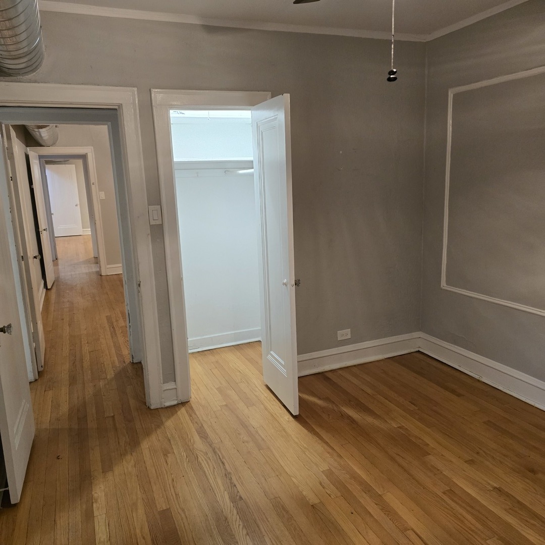 7529 North Claremont Avenue, Unit 2 Chicago, IL 60645 - Photo 21 of 24 wooden floor in an empty room