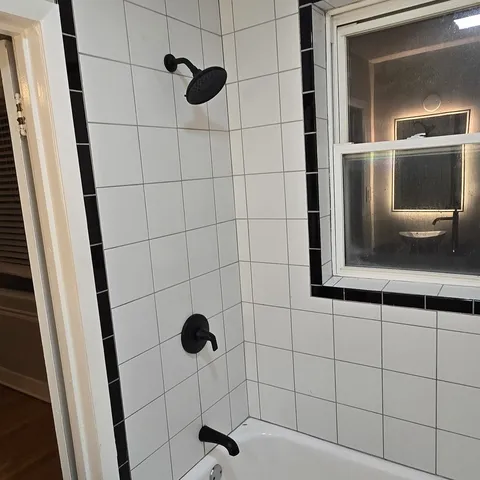 a bathroom with a shower and mirror