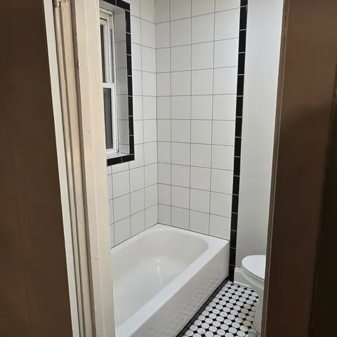 a bathroom with a bathtub and a shower