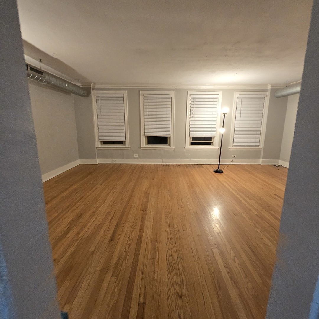 7529 North Claremont Avenue, Unit 2 Chicago, IL 60645 - Photo 6 of 24 a view of empty room with wooden floor and fan