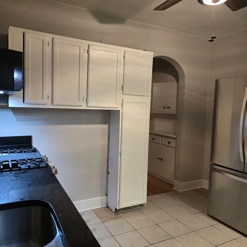a kitchen with a refrigerator and cabinets