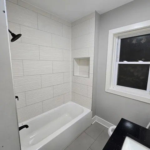 a bathroom with a bathtub and a shower