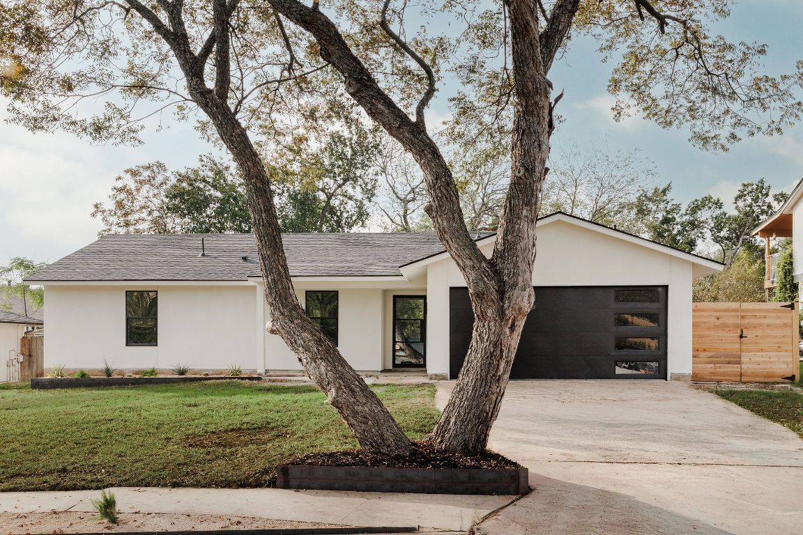 2009 Lear Lane Austin, TX 78745 - Photo 2 of 38 Gorgeous Stucco exterior, new modern garage door, black/white windows plus landscaping