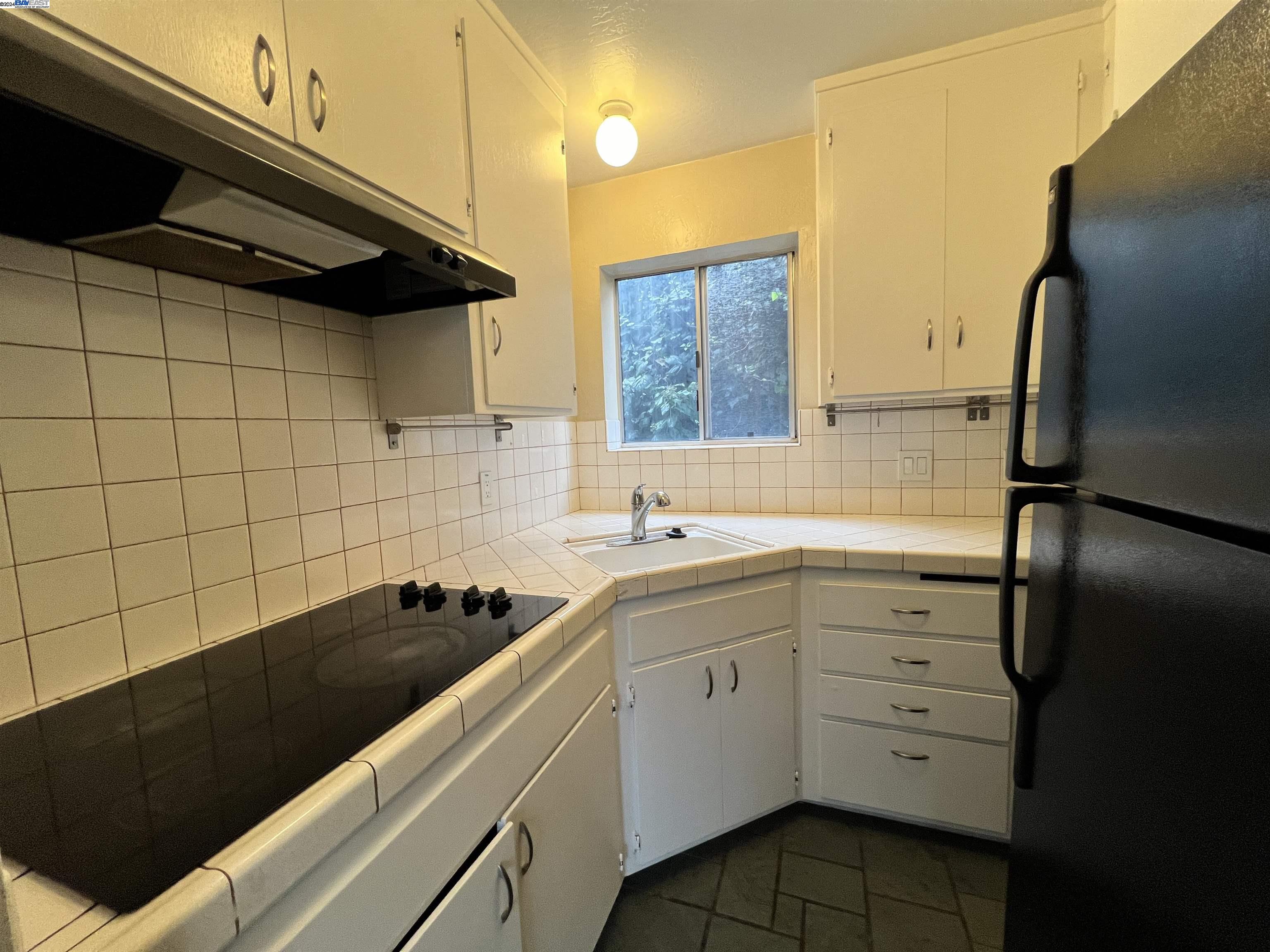 2418 Ashby Avenue, Unit B Berkeley, CA 94705 - Photo 11 of 17 a kitchen with a refrigerator and a sink