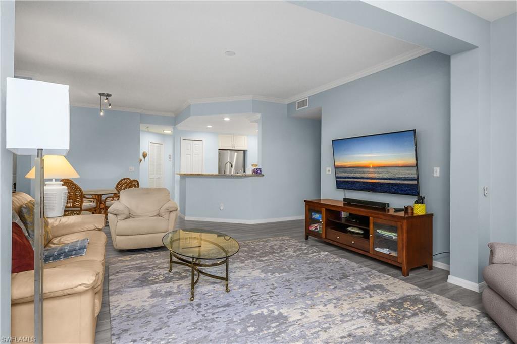 963 Egrets Run, Unit 102 Naples, FL 34108 - Photo 14 of 39 a living room with furniture and a flat screen tv