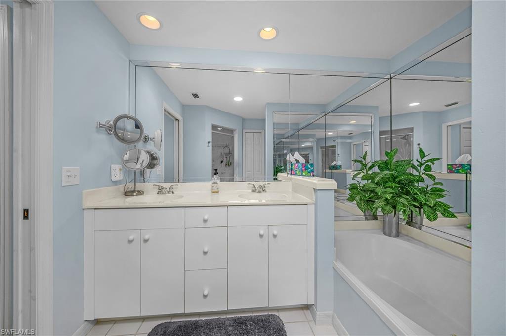 963 Egrets Run, Unit 102 Naples, FL 34108 - Photo 23 of 39 a bathroom with a potted plant and a sink