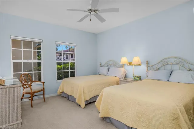 a bedroom with two beds and a window