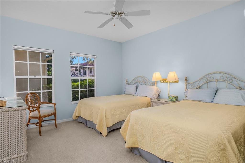 963 Egrets Run, Unit 102 Naples, FL 34108 - Photo 24 of 39 a bedroom with two beds and a window