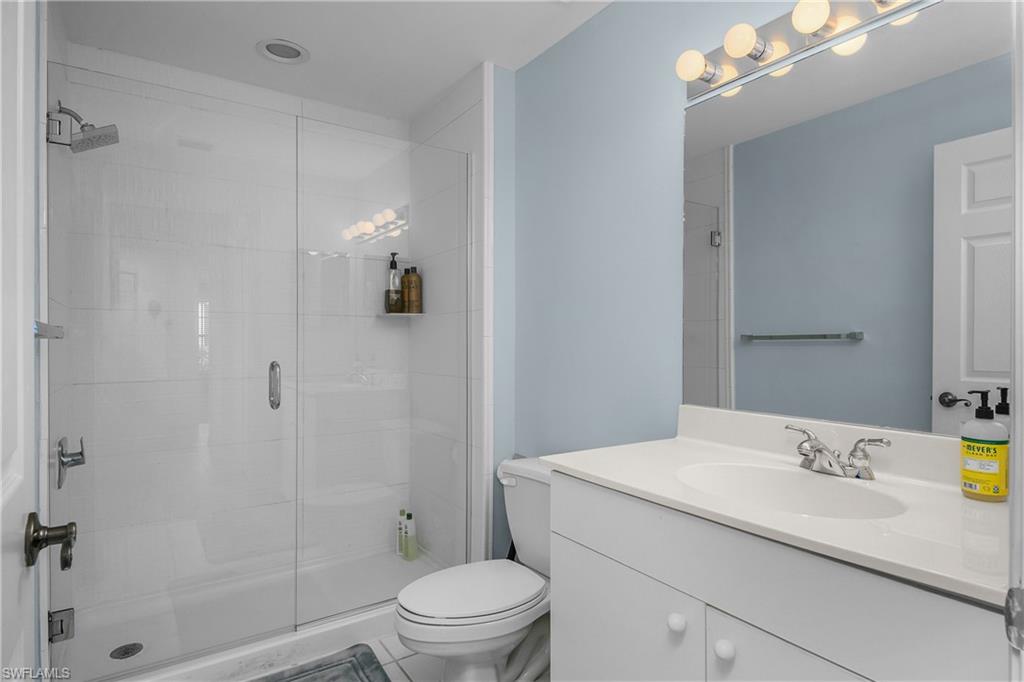 963 Egrets Run, Unit 102 Naples, FL 34108 - Photo 25 of 39 a bathroom with a sink a toilet and shower