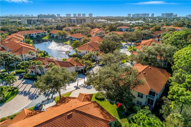 an aerial view of residential houses with city view