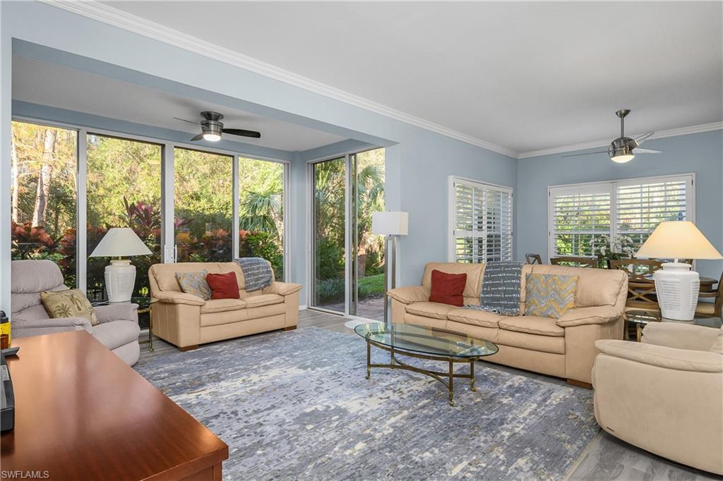 963 Egrets Run, Unit 102 Naples, FL 34108 - Photo 5 of 39 a living room with furniture and a large window