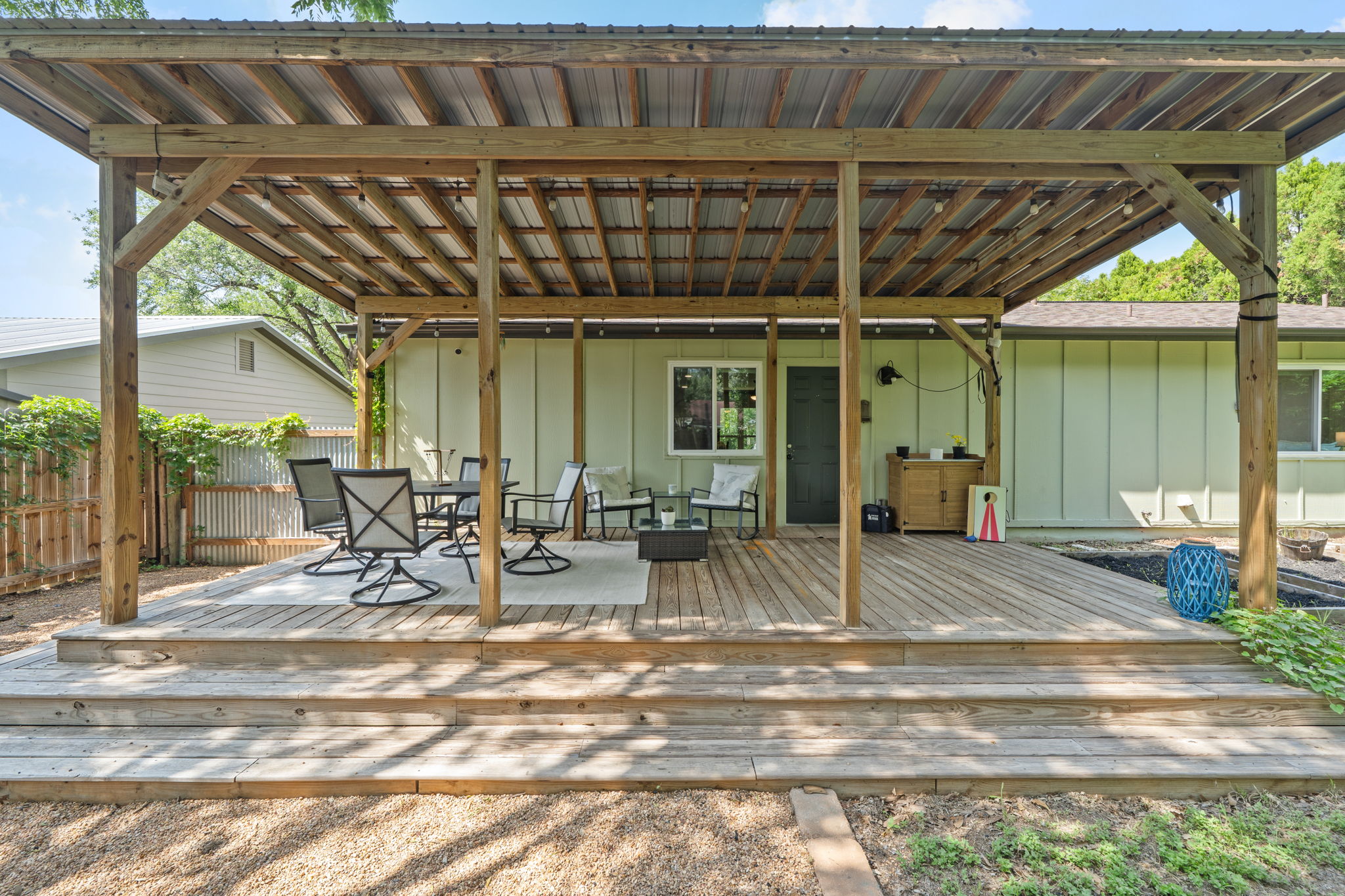 705 Dulwich Street Austin, TX 78748 - Photo 22 of 36 A spacious wooden deck provides an inviting outdoor entertaining area, featuring a covered patio and ample seating.