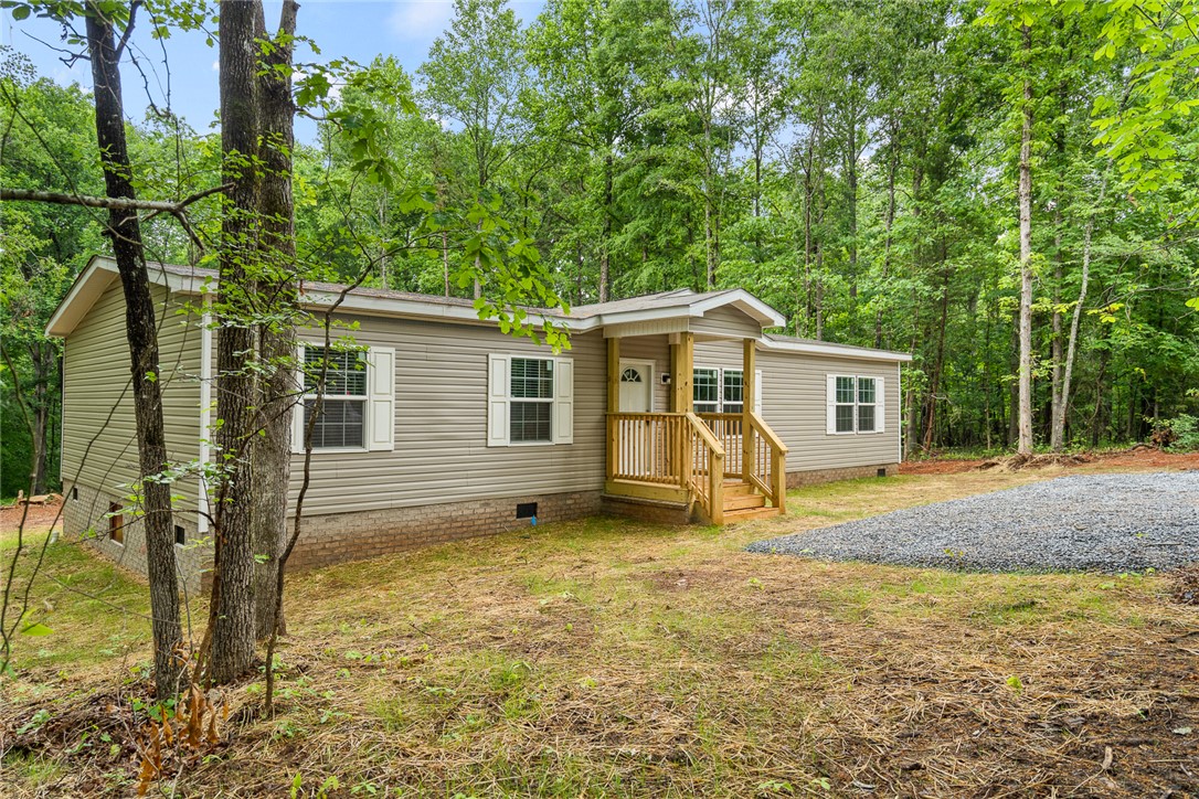 419 Austin Drive Anderson, SC 29624 - Photo 2 of 36 A charming residence surrounded by lush trees, offering a serene escape.