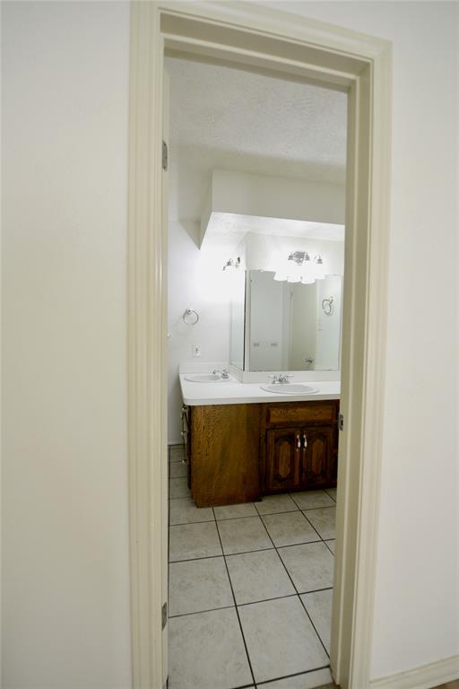 2021 Mill Pond Road Garland, TX 75044 - Photo 12 of 20 a bathroom with a bathtub and a sink