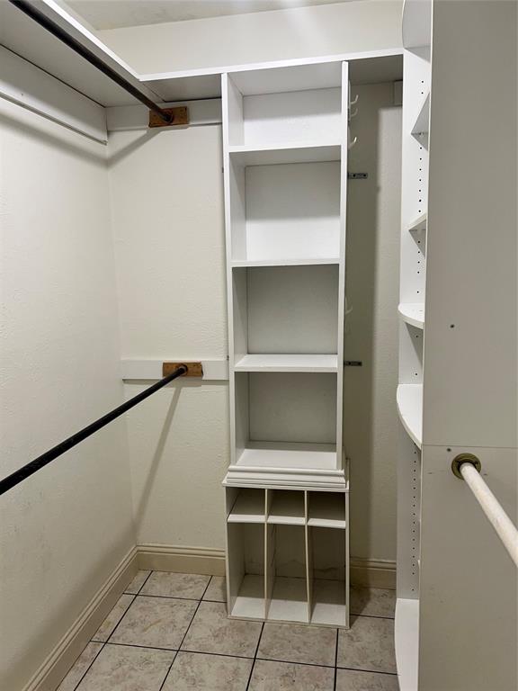 2021 Mill Pond Road Garland, TX 75044 - Photo 13 of 20 a room with walk in closet and wooden floor