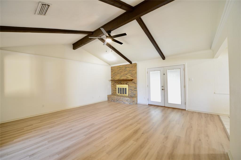 2021 Mill Pond Road Garland, TX 75044 - Photo 2 of 20 a view of an empty room with wooden floor and a window