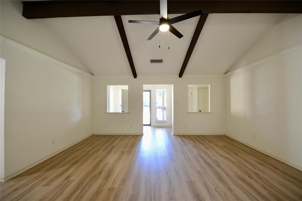 2021 Mill Pond Road Garland, TX 75044 - Photo 3 of 20 an empty room with wooden floor and windows