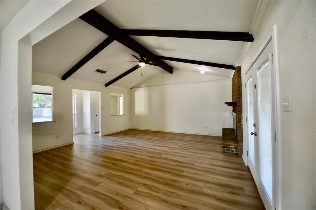 2021 Mill Pond Road Garland, TX 75044 - Photo 4 of 20 a view of a hallway with wooden floor and staircase