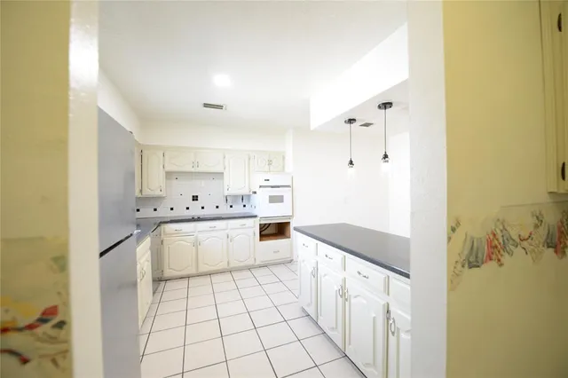 a kitchen with granite countertop a sink and cabinets