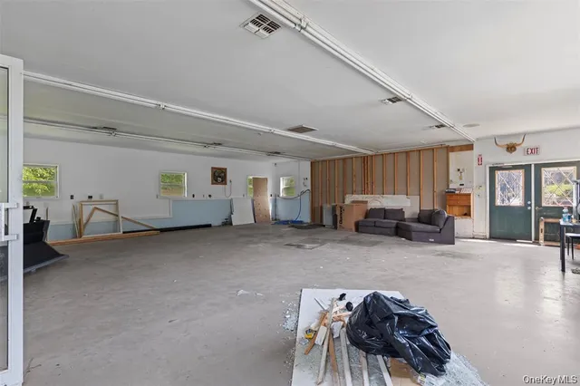 a view of a livingroom with furniture and windows