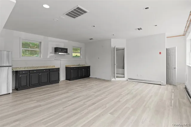 a view of a kitchen with wooden floor and a sink