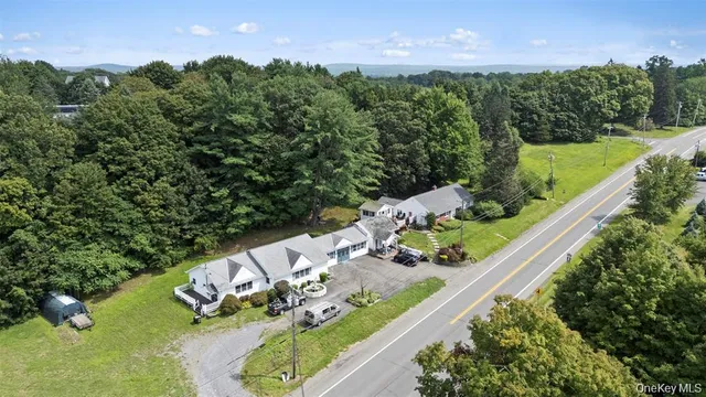 an aerial view of a house with a yard