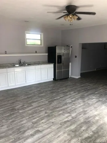 an aerial view of a house with yard and mountain view in back