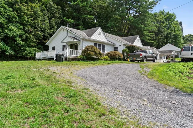a front view of a house with a yard and trees